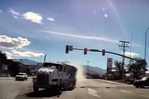 Runaway double-bottom semi takes out 33 cars as it barrels into dealership